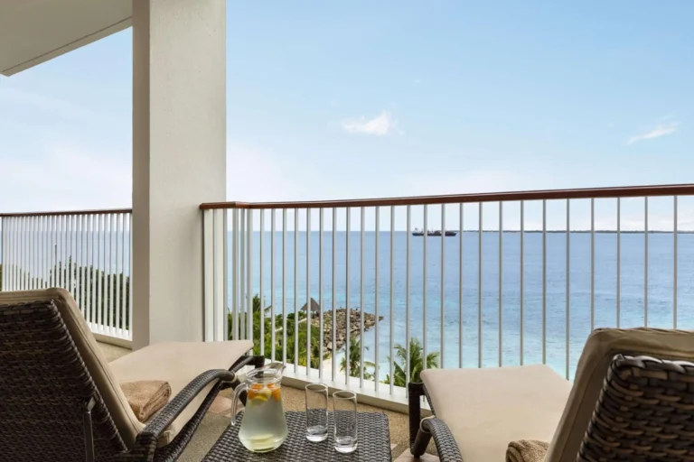 Sun loungers and a sea view from a private room balcony at Shangri-La Mactan, Cebu