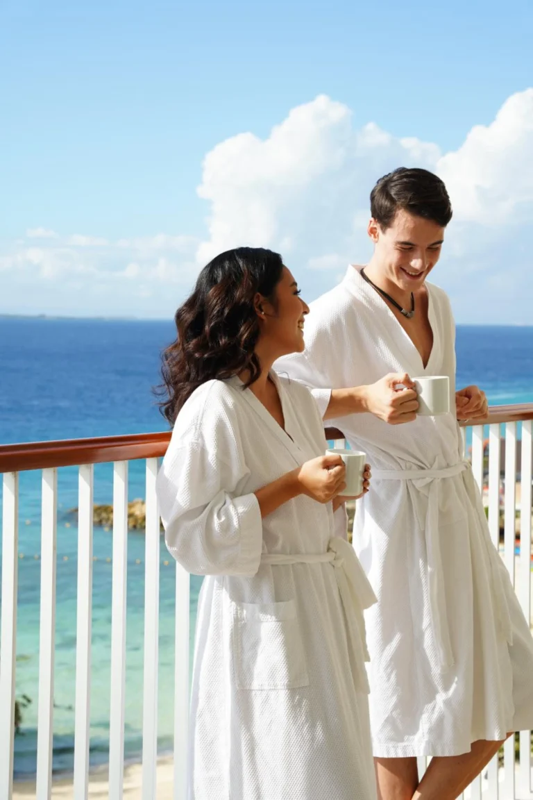 Guests in bathrobes enjoying coffee on a sea-view balcony at Shangri-La Mactan, Cebu