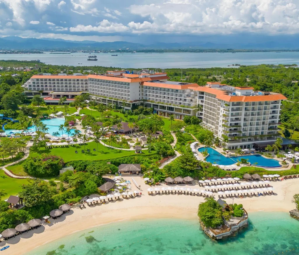 A drone view of Shangri-La Mactan, Cebu's pools, beach loungers and Treasure Island