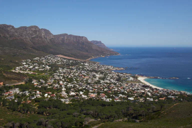 Camps Bay and Clifton beneath the Twelve Apostles ridge, with turquoise Atlantic water and white sand