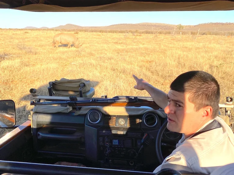 Family with a young child watching zebras from a private safari vehicle at Morukuru Family Madikwe