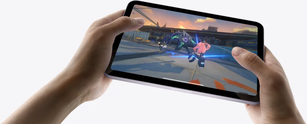iPad mini A17 Pro held two-handed in landscape, gaming in use