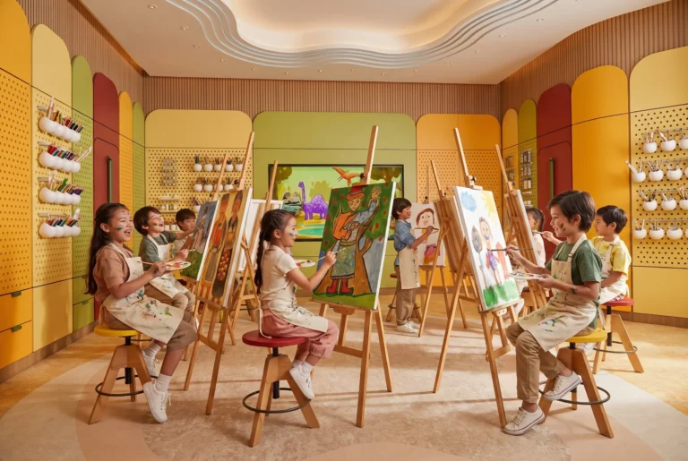 Children painting at easels in the Atlantis Explorers Club art studio