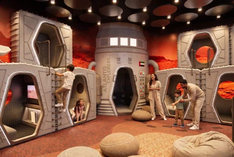 Parents and children exploring the Mars-themed play zone at the Atlantis Explorers Club