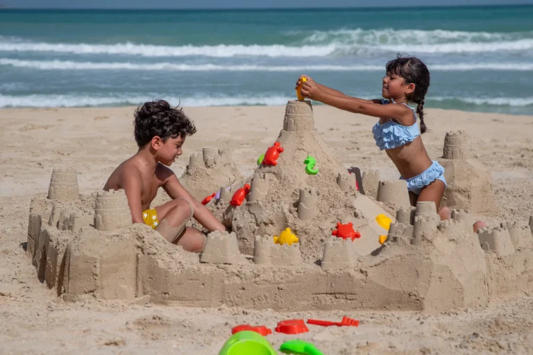 Children building a sandcastle at Sinbad's Kids Club, Jumeirah Al Qasr