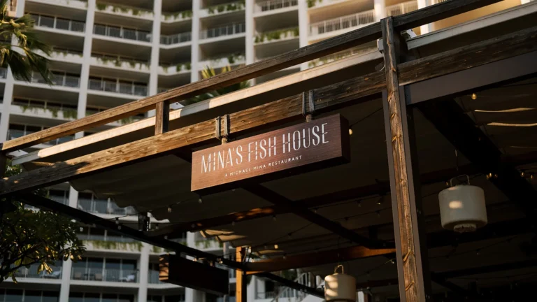 Mina's Fish House restaurant entrance sign on a wooden pergola at Four Seasons Resort Oahu at Ko Olina