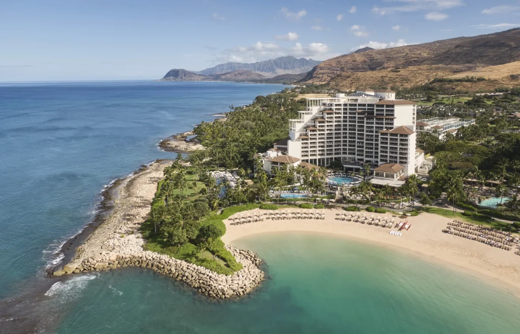 Aerial view of Four Seasons Resort Oahu at Ko Olina with Ko Olina beach, lagoon, pool areas and Waianae mountains