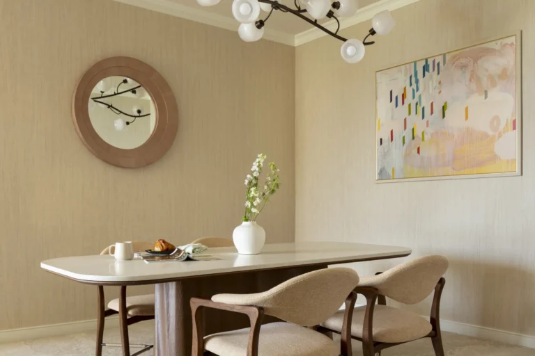 Club Lounge private dining room at Four Seasons Resort Oahu with round table, modern chandelier and colourful Hawaiian artwork