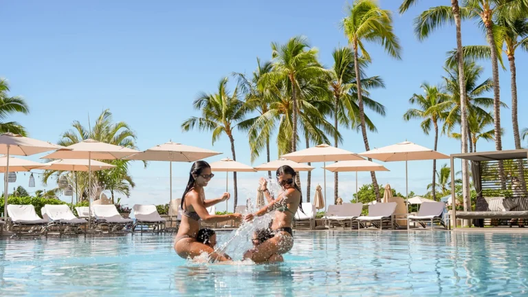 Family splashing and playing in the Ohana Pool at Four Seasons Resort Oahu at Ko Olina