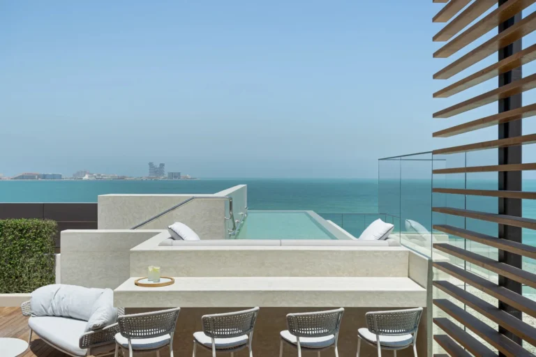 Private rooftop terrace at Jumeirah Al Naseem with a plunge pool, sun loungers and outdoor seating, looking over the resort grounds to the Arabian Gulf and Palm Jumeirah on the horizon