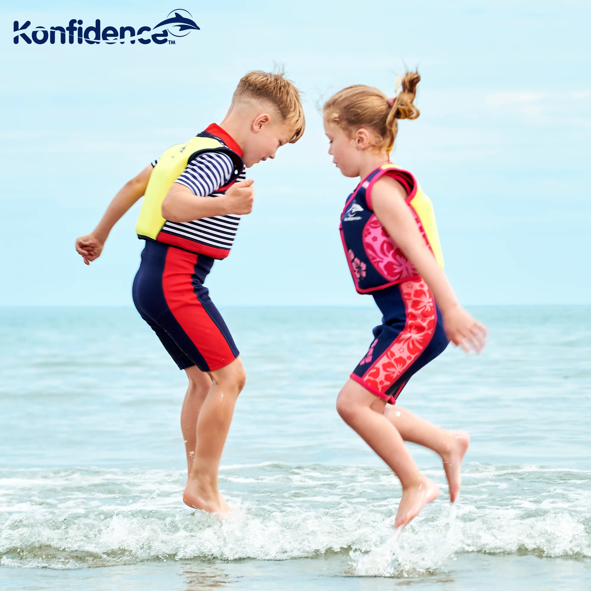 Child wearing the Konfidence Original Jacket buoyancy swim vest with bright yellow back panel at a hotel pool