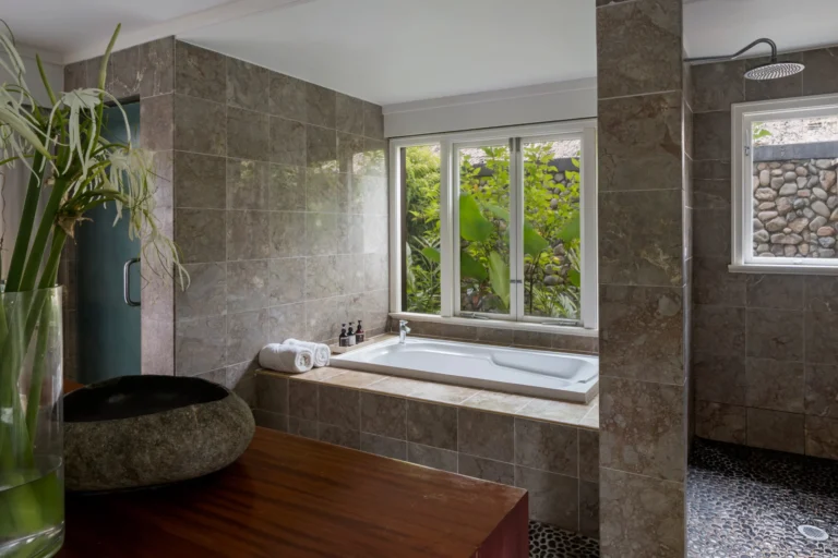 Suite bathroom at Nanuku Resort Fiji with stone vanity and soaking tub