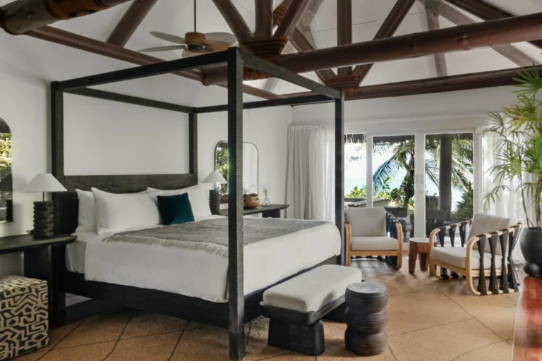 Beachfront spa suite bedroom at Nanuku Resort with four-poster bed