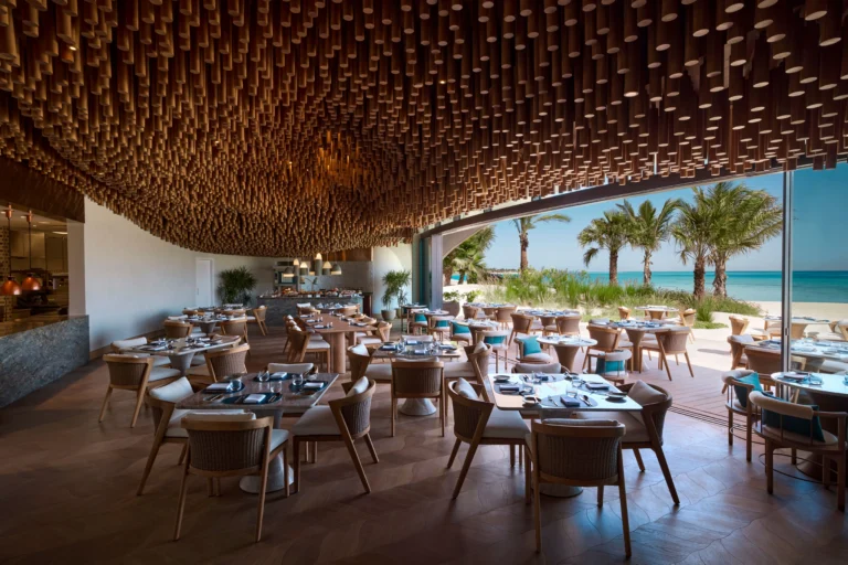 Lunara restaurant interior at Shebara Resort with elegant dining tables overlooking the Red Sea