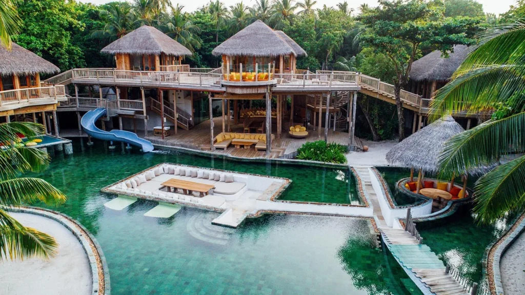 Aerial drone view of Soneva Fushi overwater villas and Kunfunadhoo island, Baa Atoll