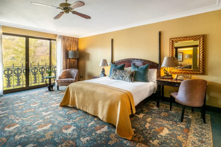 Junior Suite bedroom with four-poster bed and private balcony