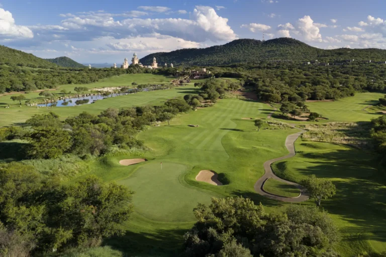 Aerial view of the Gary Player-designed Lost City Golf Course with The Palace in the distance