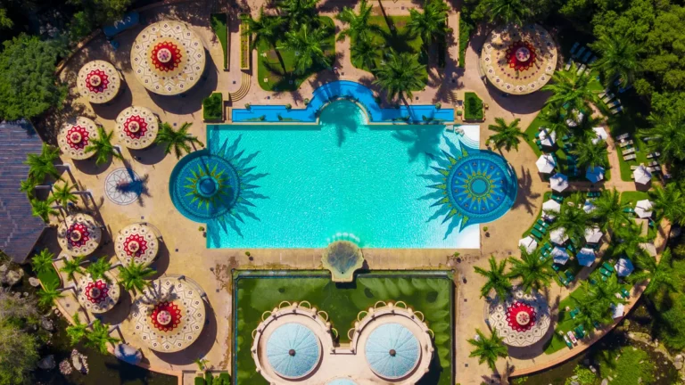 Aerial view of the Palace's starburst-mosaic swimming pool and gazebo sun loungers
