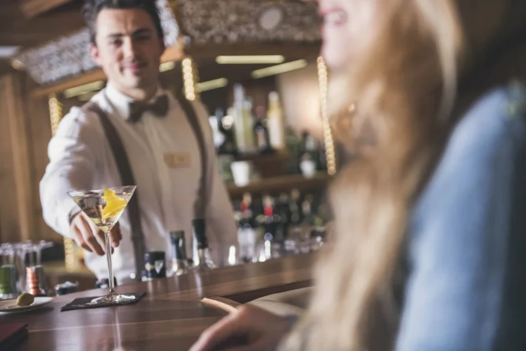 Bartender serving a cocktail at the hotel bar, Cavallino Bianco