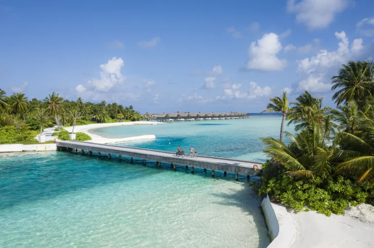 A guest cycles across the bridge connecting Niyama's two islands, Play and Chill