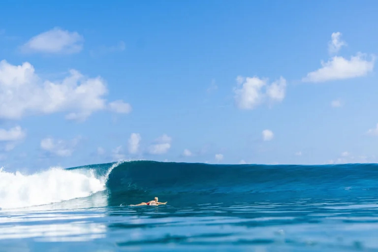 A surfer rides a wave at Vodi Point, Niyama's reef break off Play island