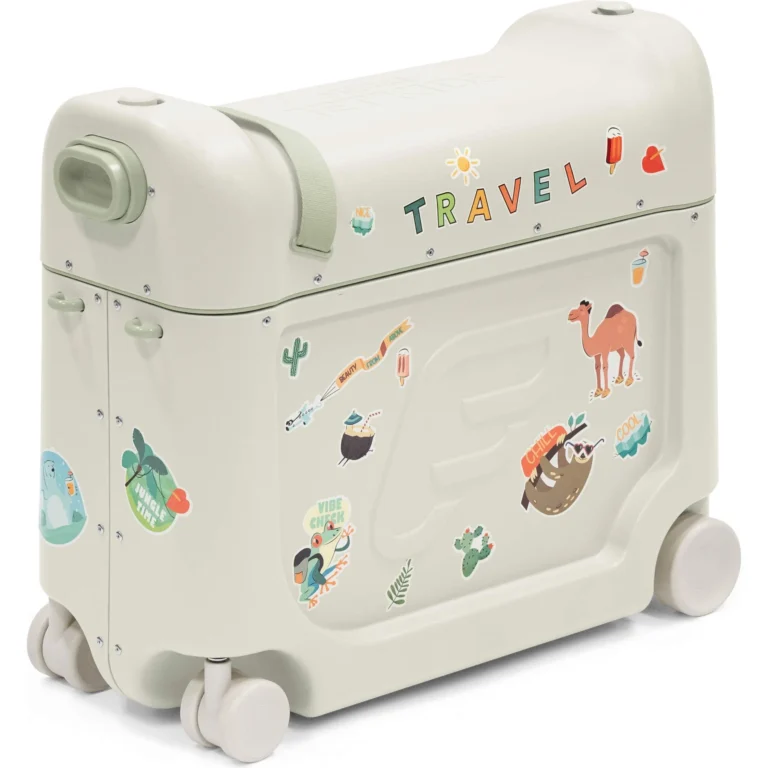 Child riding Stokke JetKids BedBox through airport terminal