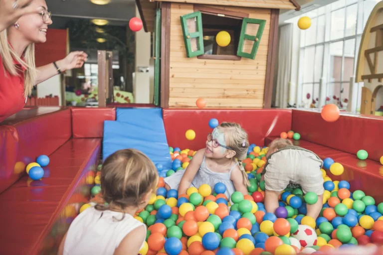 Children playing in a ball pit with a childminder at Lino Land, Cavallino Bianco