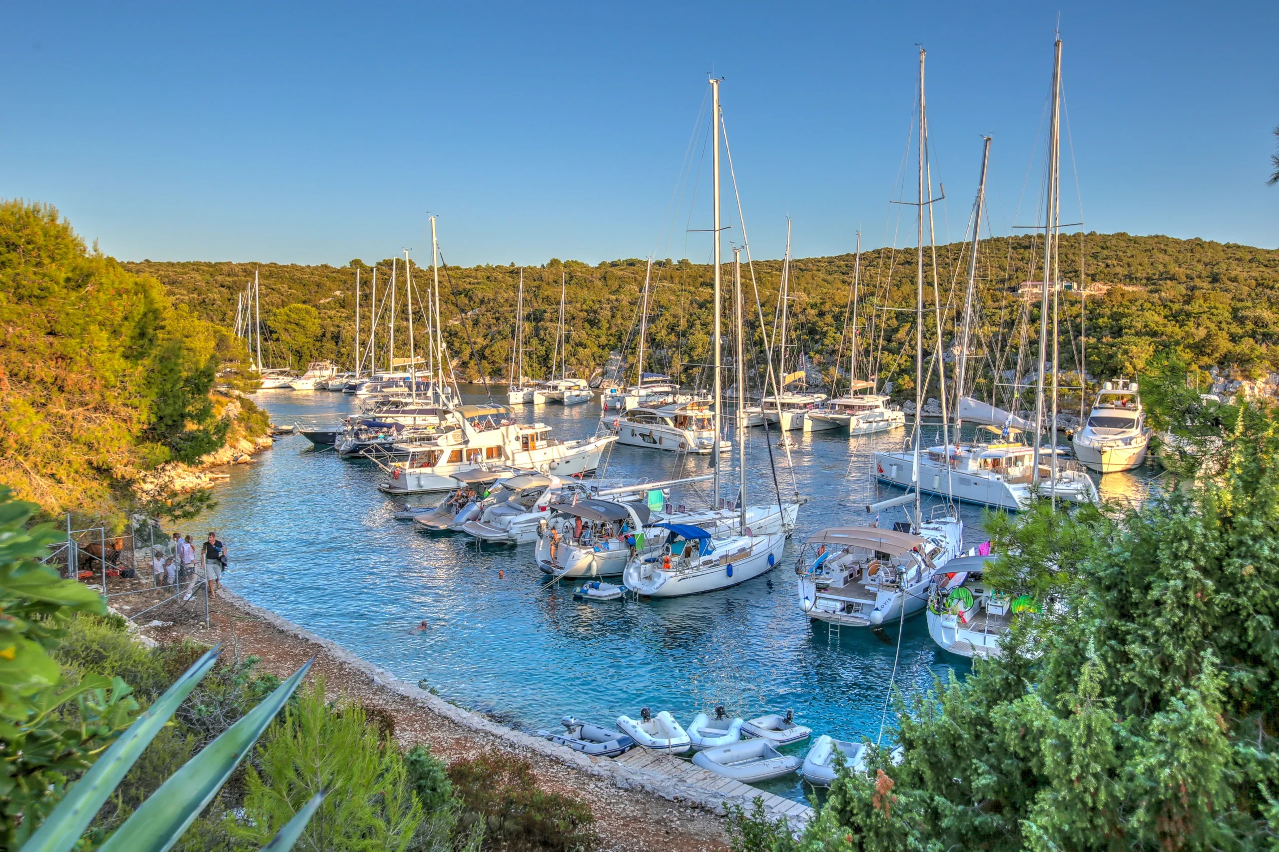 Yachts moored side by side filling the narrow Šešula bay on Šolta island, Croatia, in high season