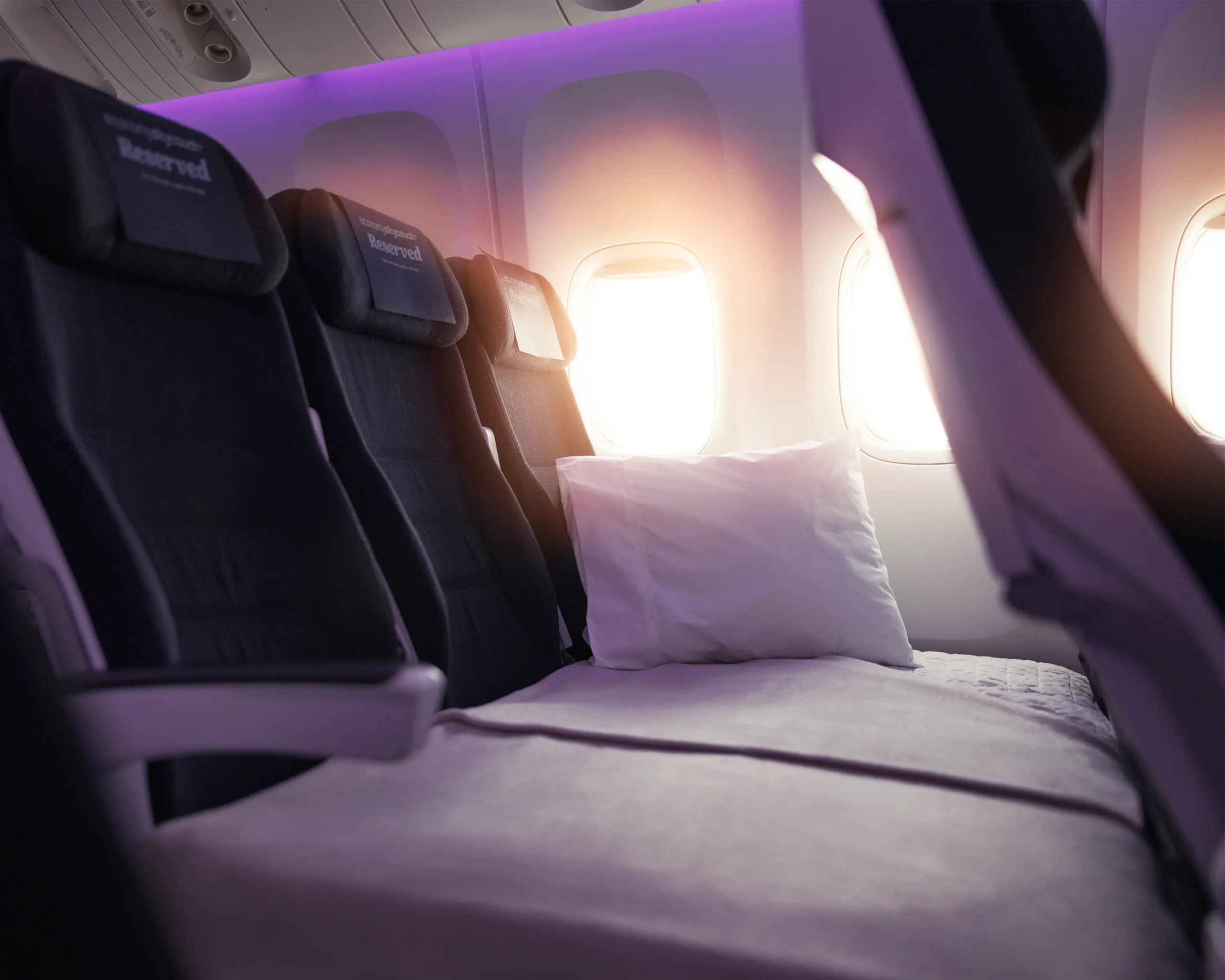 Air New Zealand Economy Skycouch made up as a flat bed across a three-seat row on the Boeing 787-9