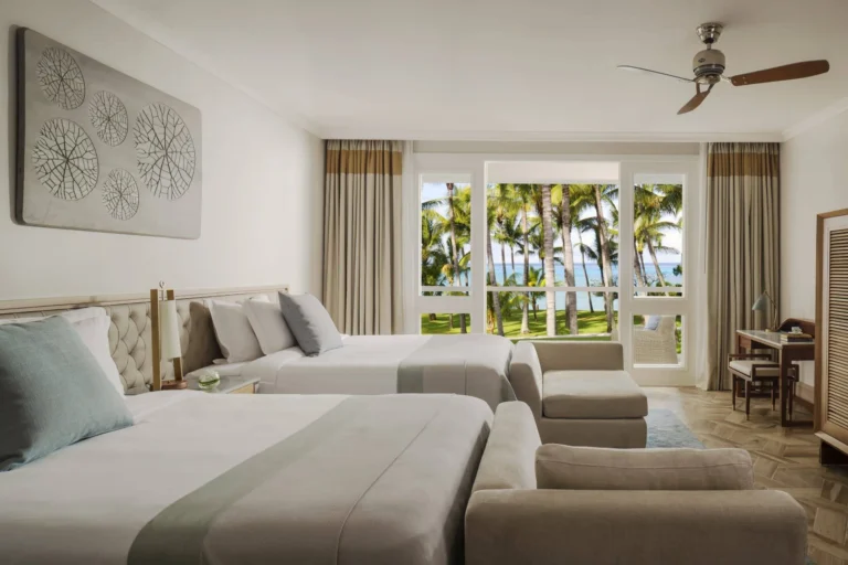 Two-Bedroom Ocean Balcony Family Suite at One&Only Le Saint Géran showing twin beds and balcony, ideal for families