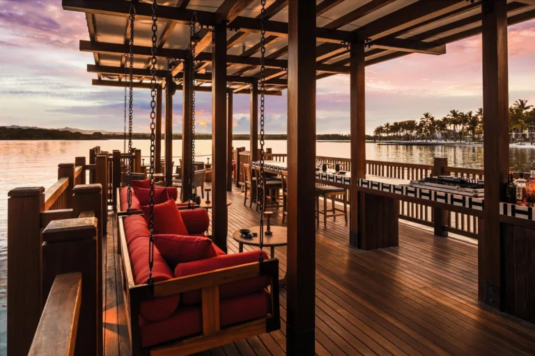 Tapasake restaurant bar at One&Only Le Saint Géran at sunset — over-water deck with Indian Ocean panorama