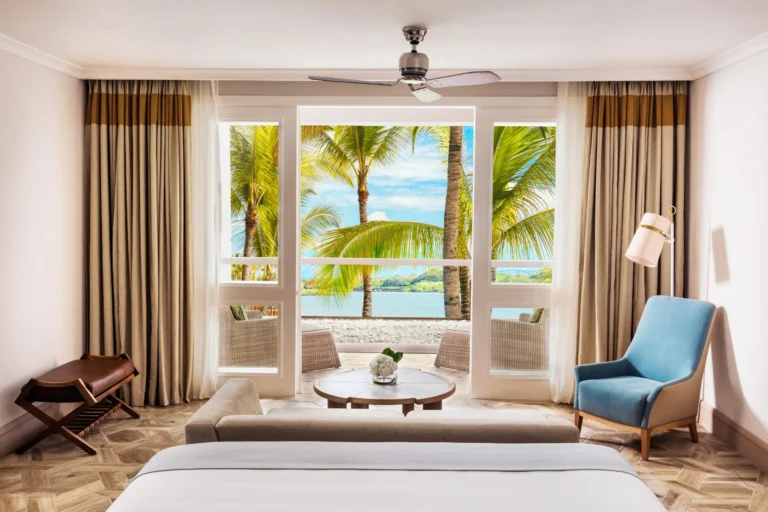 Lagoon Balcony Room interior at One&Only Le Saint Géran with ocean-view terrace, light contemporary décor