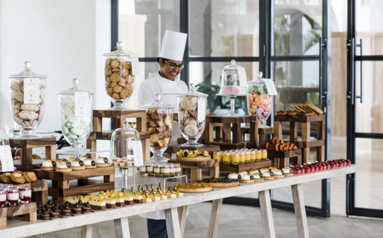L'Artisan at One&Only Le Saint Géran — chef presenting artisan pastries and bread on a marble counter