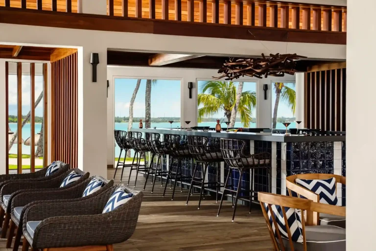 La Terrasse bar interior at One&Only Le Saint Géran — woven seating, tropical light, ocean-facing open walls