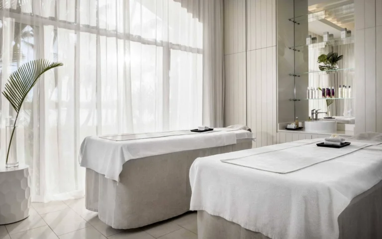 Guerlain Spa couples treatment room at One&Only Le Saint Géran — side-by-side massage beds, terracotta textures