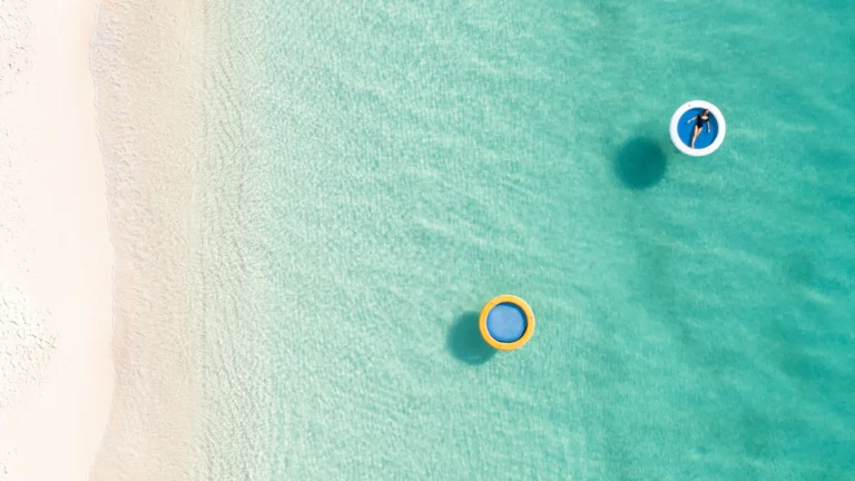 Beach lifestyle and floating-water activity on Seven Mile Beach
