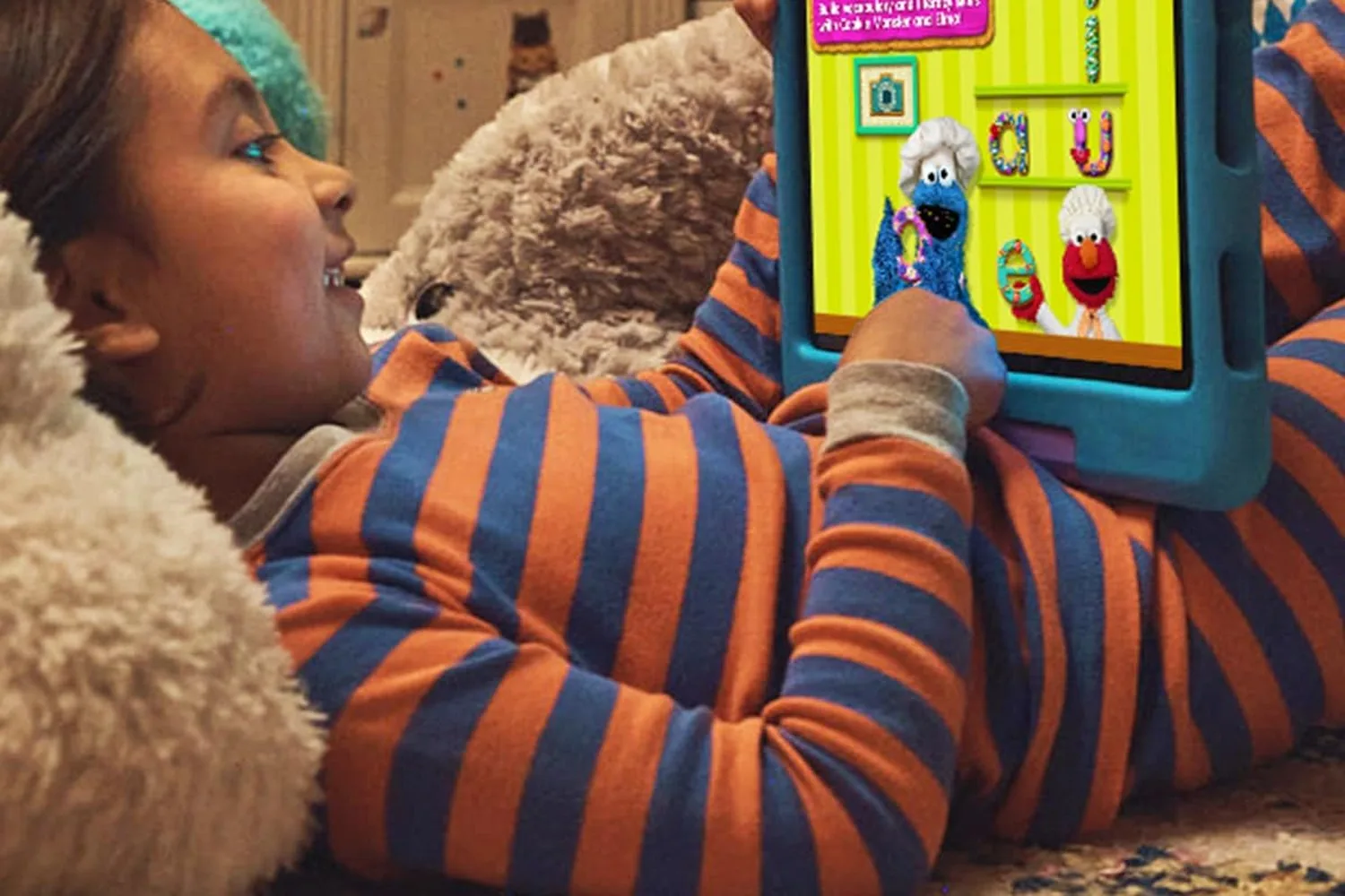 Amazon Fire HD 10 Kids tablet on a poolside chair showing its LCD screen in bright outdoor light
