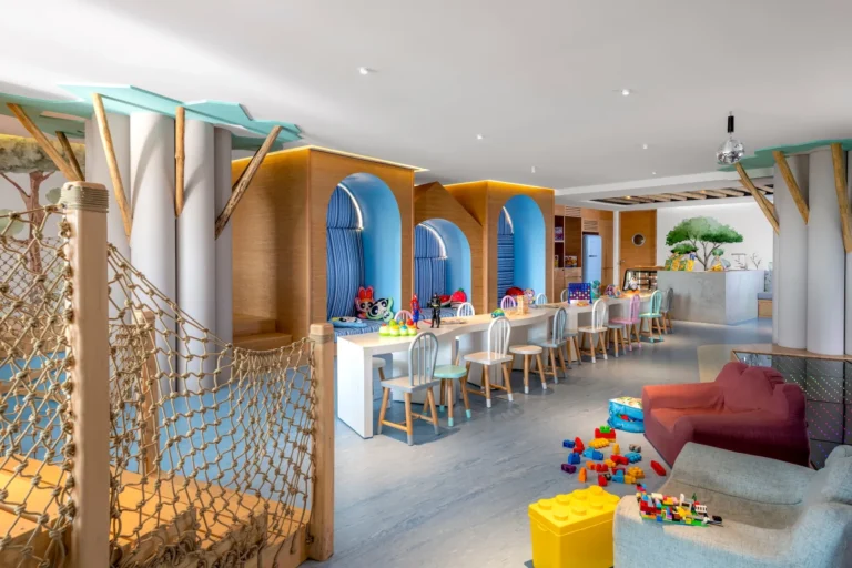 Kids Club outdoor play area with tree and swings at Grand Velas Los Cabos
