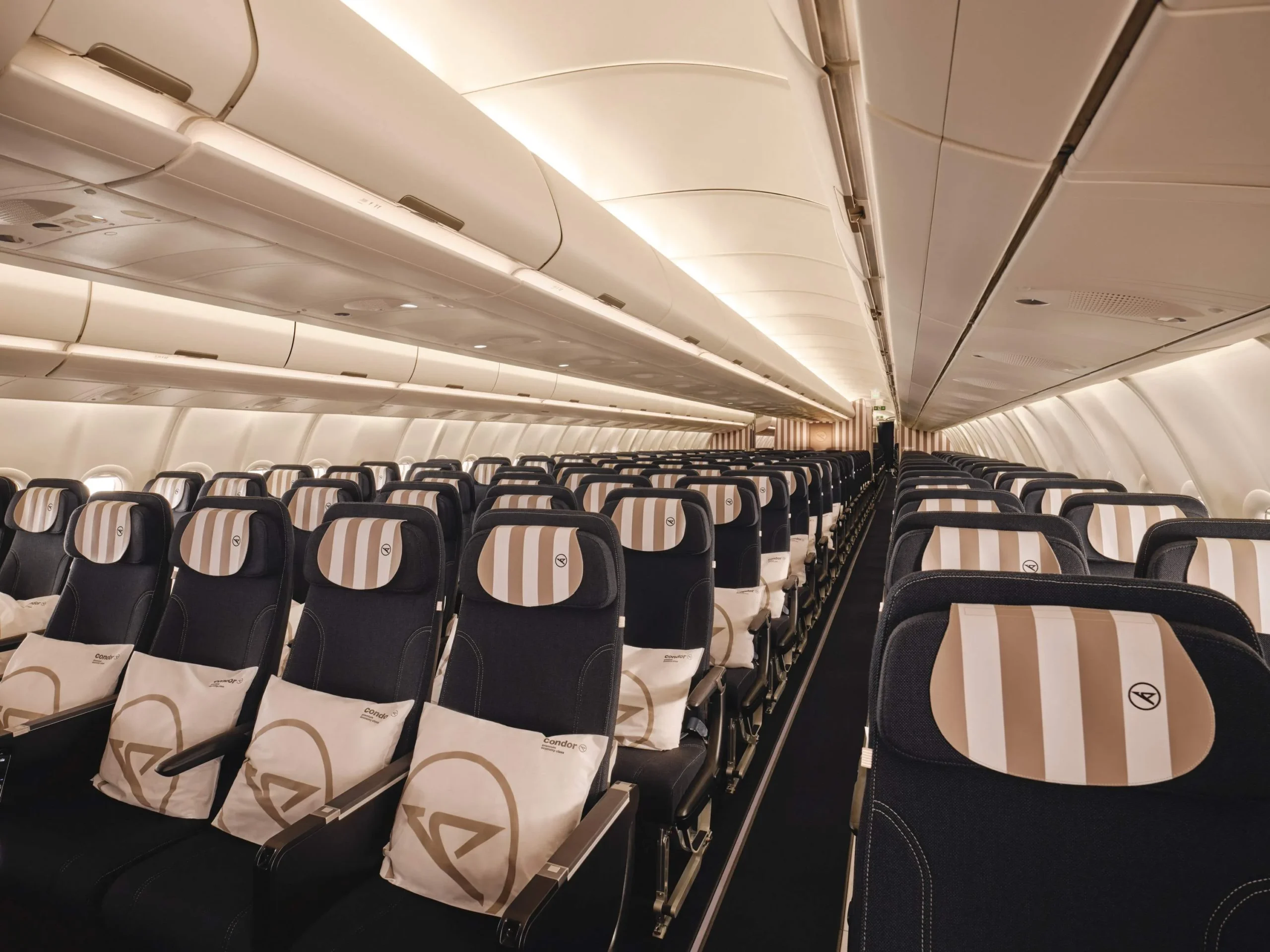 Condor A330neo Premium Economy class cabin interior with striped seat headrests in a 2-4-2 configuration