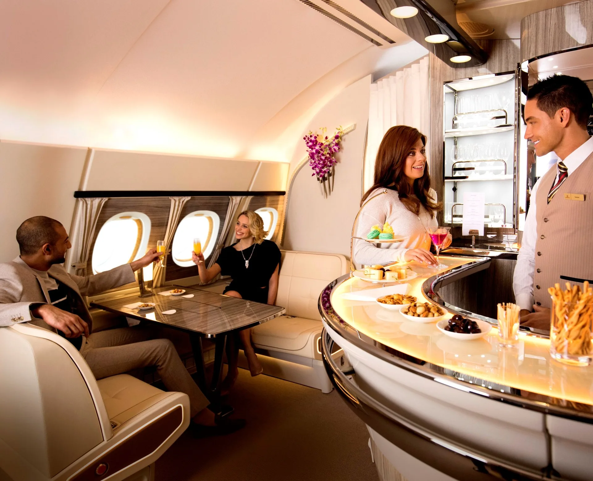 Emirates A380 Onboard Lounge with crew serving guests at the horseshoe-shaped bar