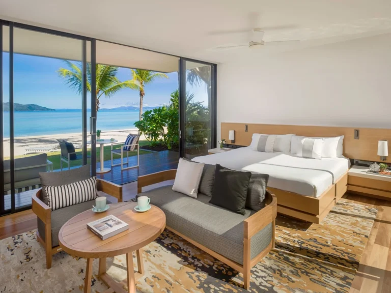Beachfront room with a king bed, lounge and sliding doors onto the sand and sea