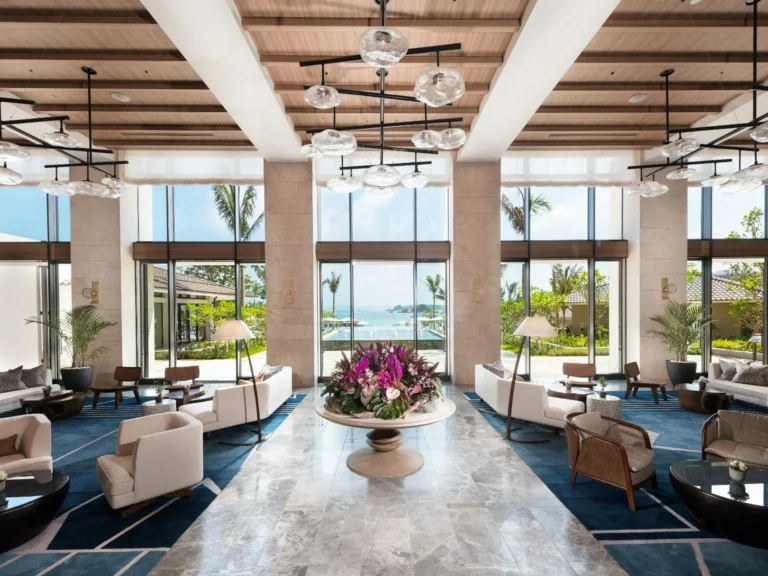 Beach Front lobby with a large orchid arrangement, marble floor and seating groups looking out to the sea