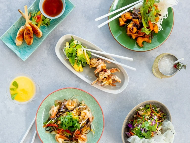 Pan-Asian dishes and cocktails photographed from above on a pale table