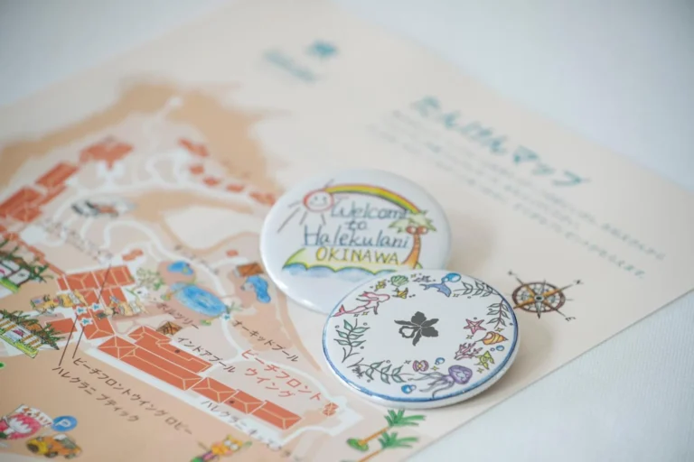 Illustrated hotel exploration map with two hand-drawn Welcome to Halekulani Okinawa badges