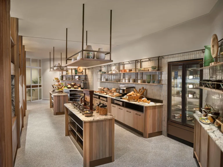 Breakfast buffet counters stacked with pastries and baked goods