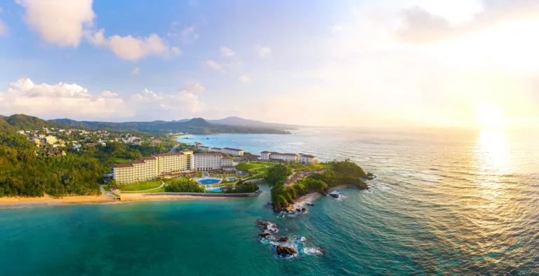 Sunset aerial of the resort on its headland with the East China Sea glowing beyond