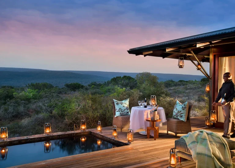 A table laid beside a suite plunge pool at Kwandwe Ecca Lodge in the evening