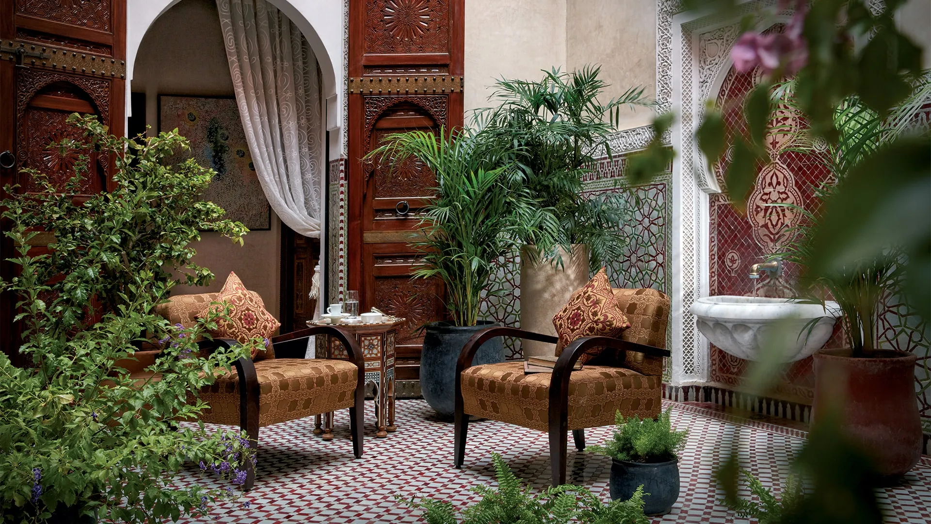 Private riad courtyard at Royal Mansour Marrakech with a central fountain and garden.