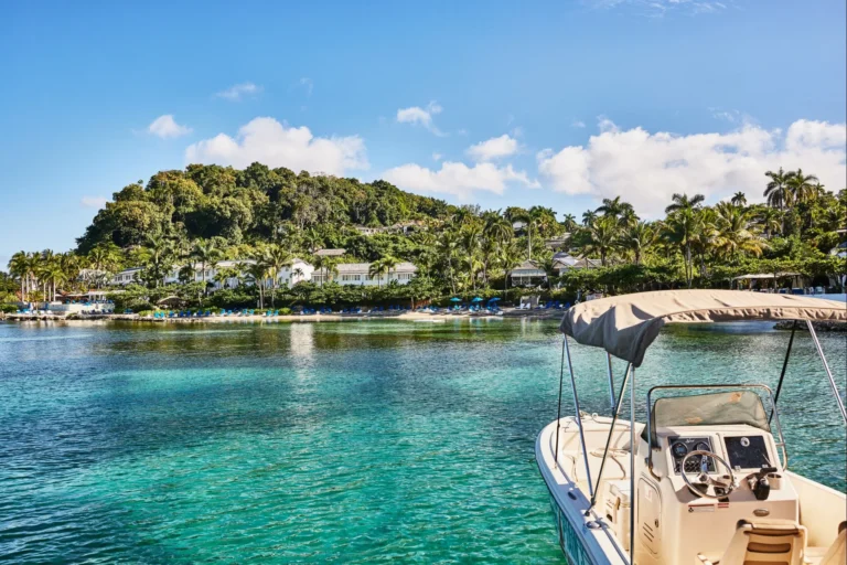 Motor boat moored in shallow turquoise water beside the peninsula